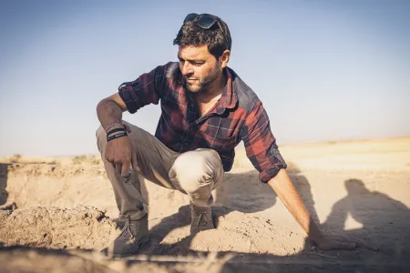 Rocco Palermo leaning over an excavation site