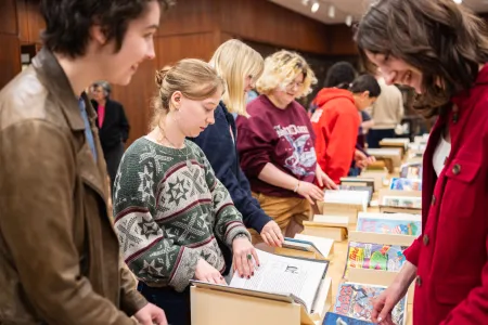 Students looking at books in special collections