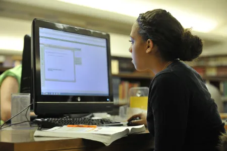 Student sitting doing work at a computer