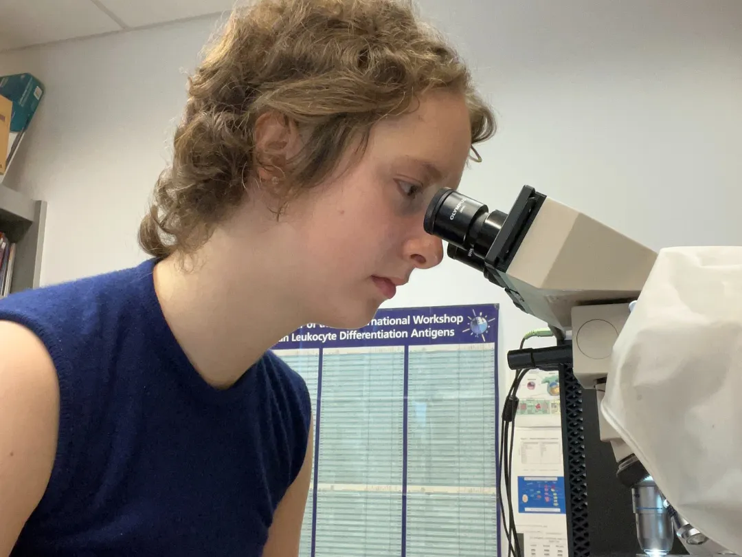 Olivia looking into a microscope