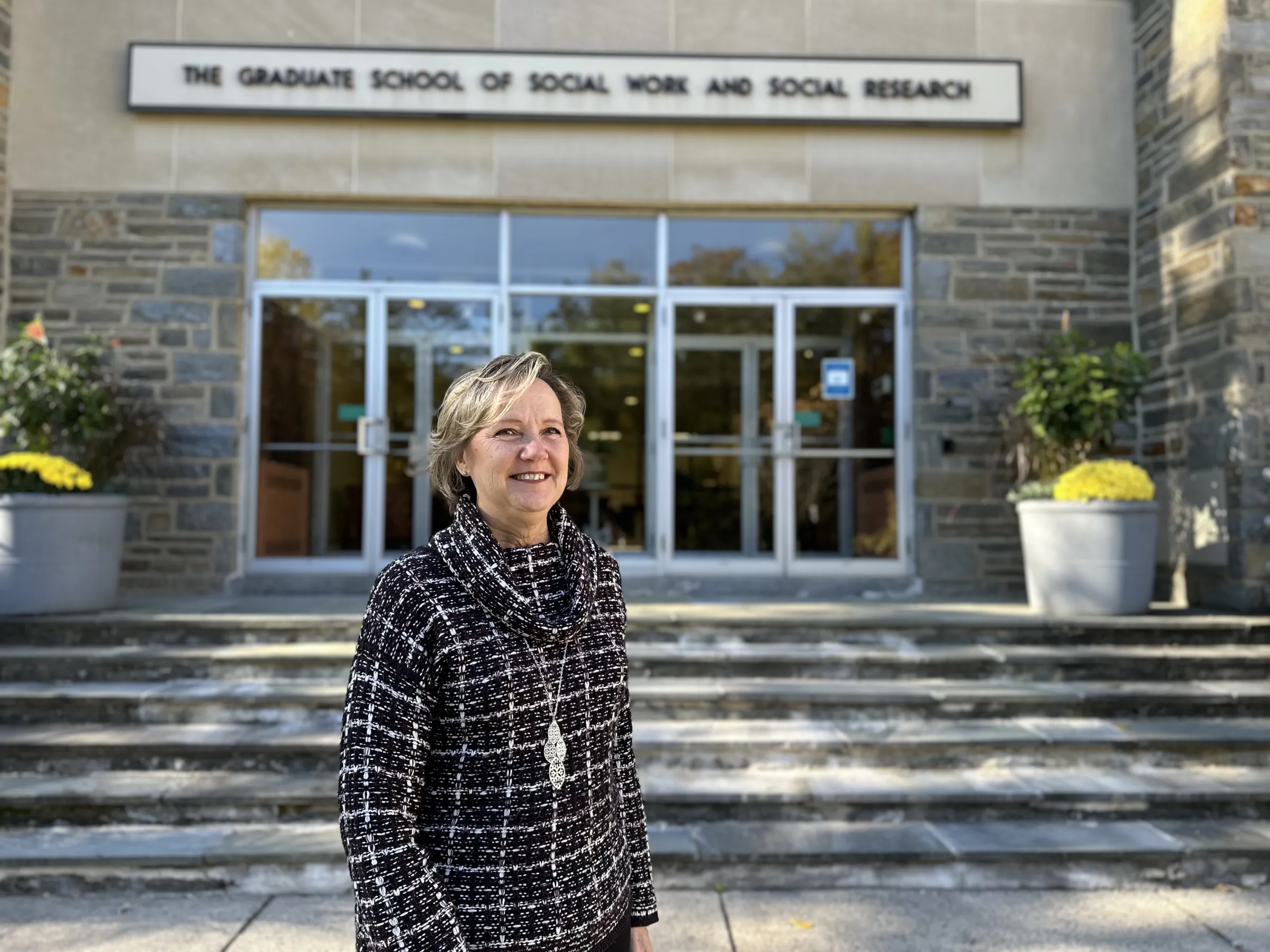Peggy Robinson standing outside of the GSSWSR building