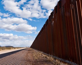 Fence at the border against a blue sky