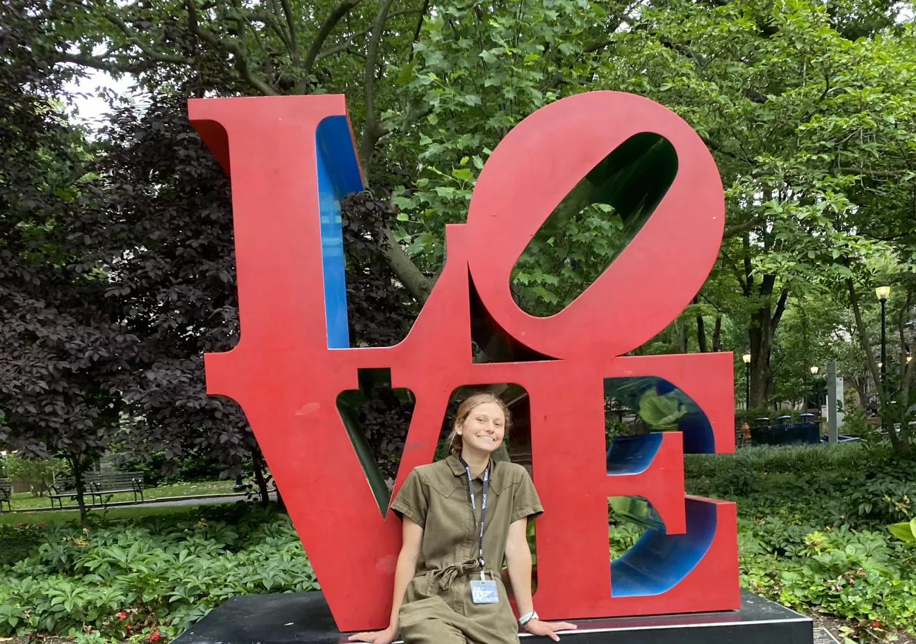 Hallie Kern sitting in front of the LOVE sign 