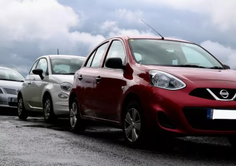 Three cars parked on a road