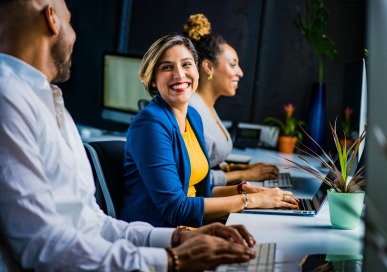 Employees working together and smiling