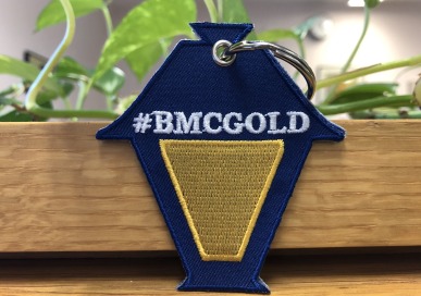 Key chain shaped like a lantern with #BMCGOLD in writing