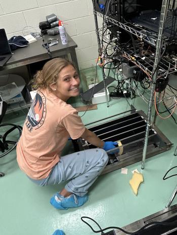 Hallie Kern tending to electronic equipment