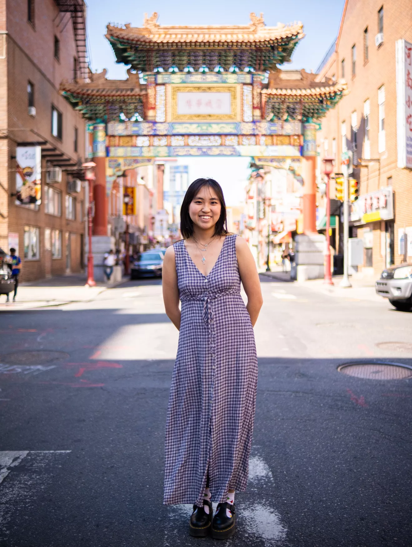 Kaia Chau standing in front of the Philadelphia Chinatown Gates