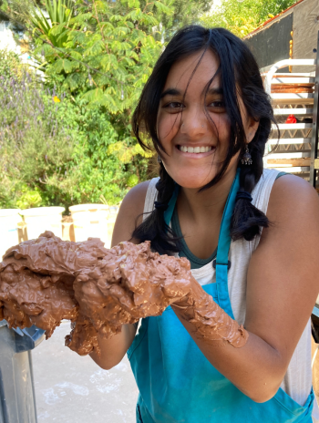 Purnima Palawat smiling while holding mud