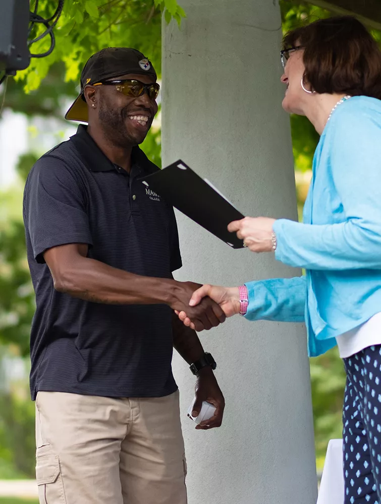 Gary Stroman accepts his McPherson Award from President Cassidy