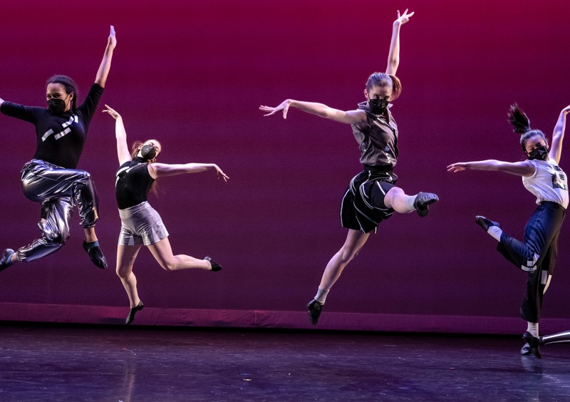 Image of dancers jumping on stage