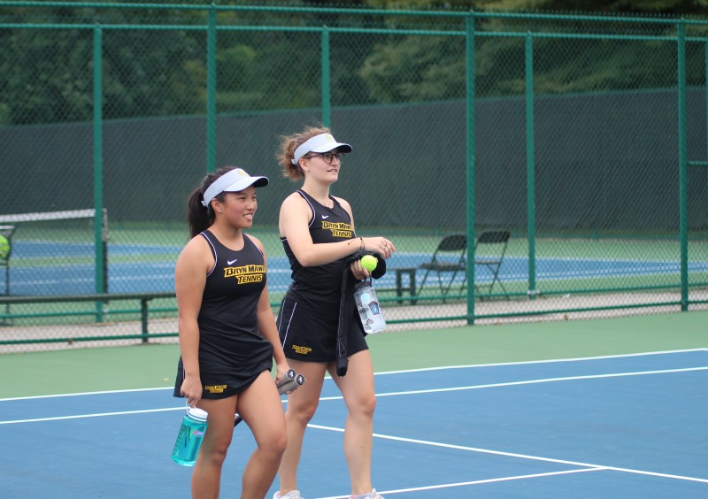 Wynn Bryant and Kelly Cole on a tennis court