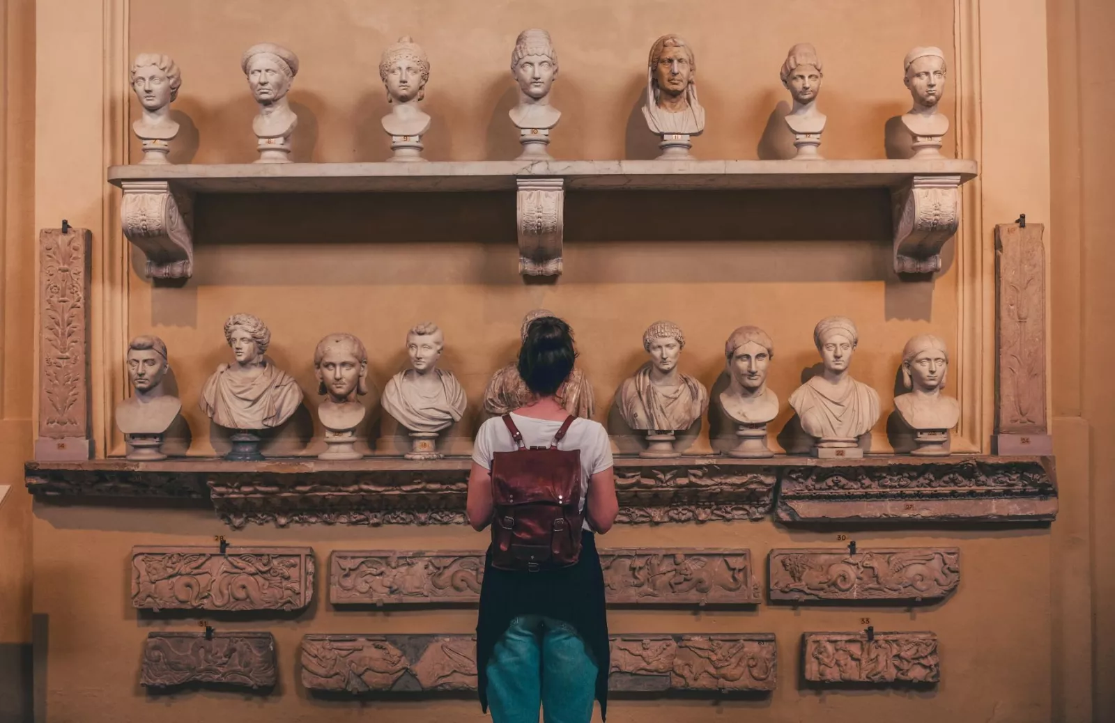 woman-watching-statues-museum