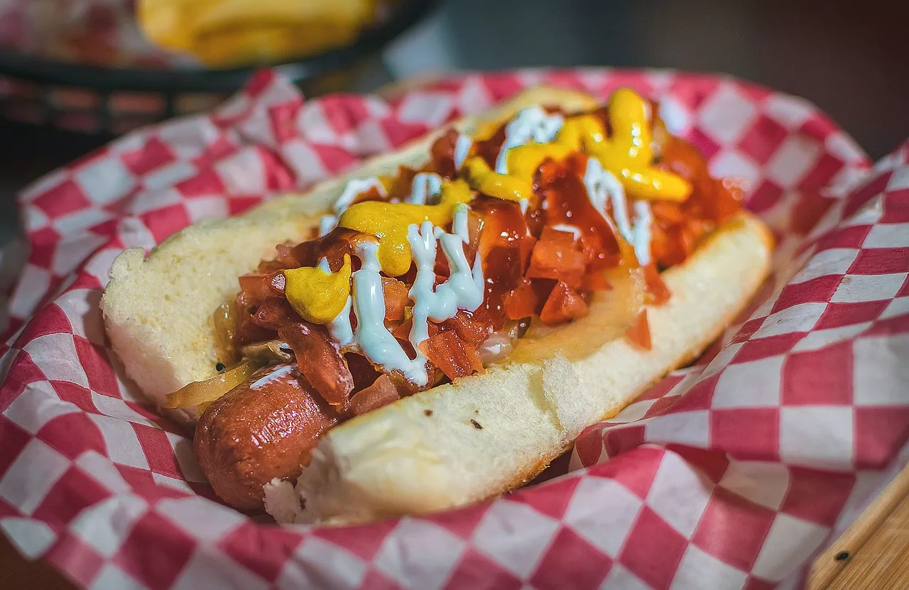 Hot dog with ketchup and mustard and toppings