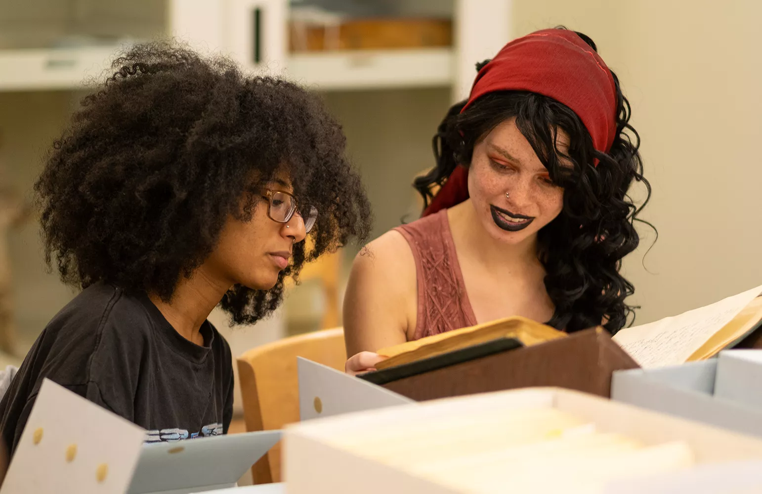 Swarthmore student Shayla Smith and Wynter Douglas '19 (from left) examine documents from Bryn Mawr's Special Collections.