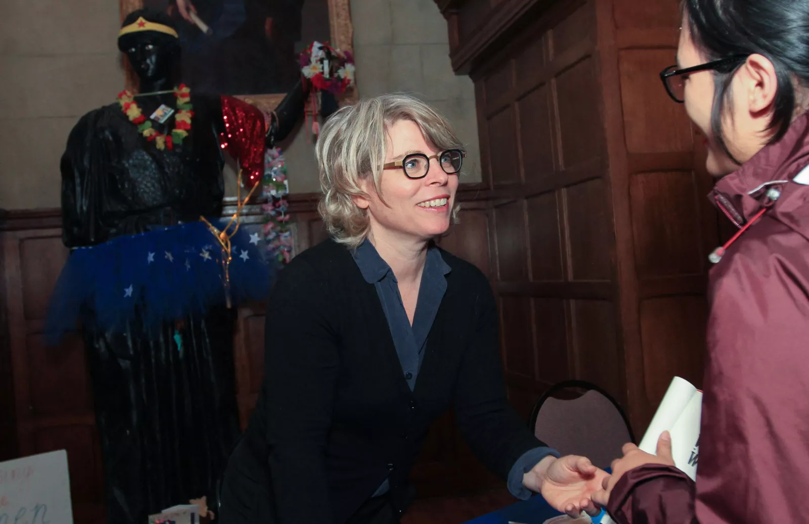 author shaking hands with student