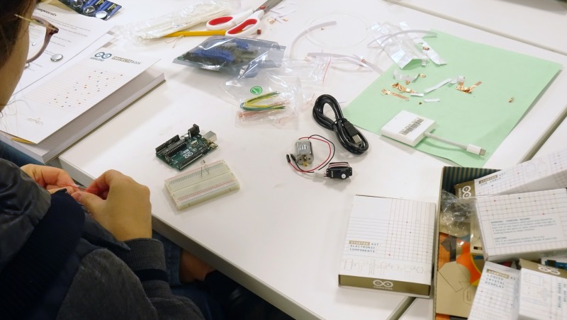 A student works on their device during the physical computing intensive