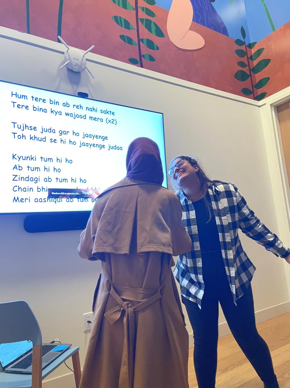 Students singing along to lyrics at Karaoke Night