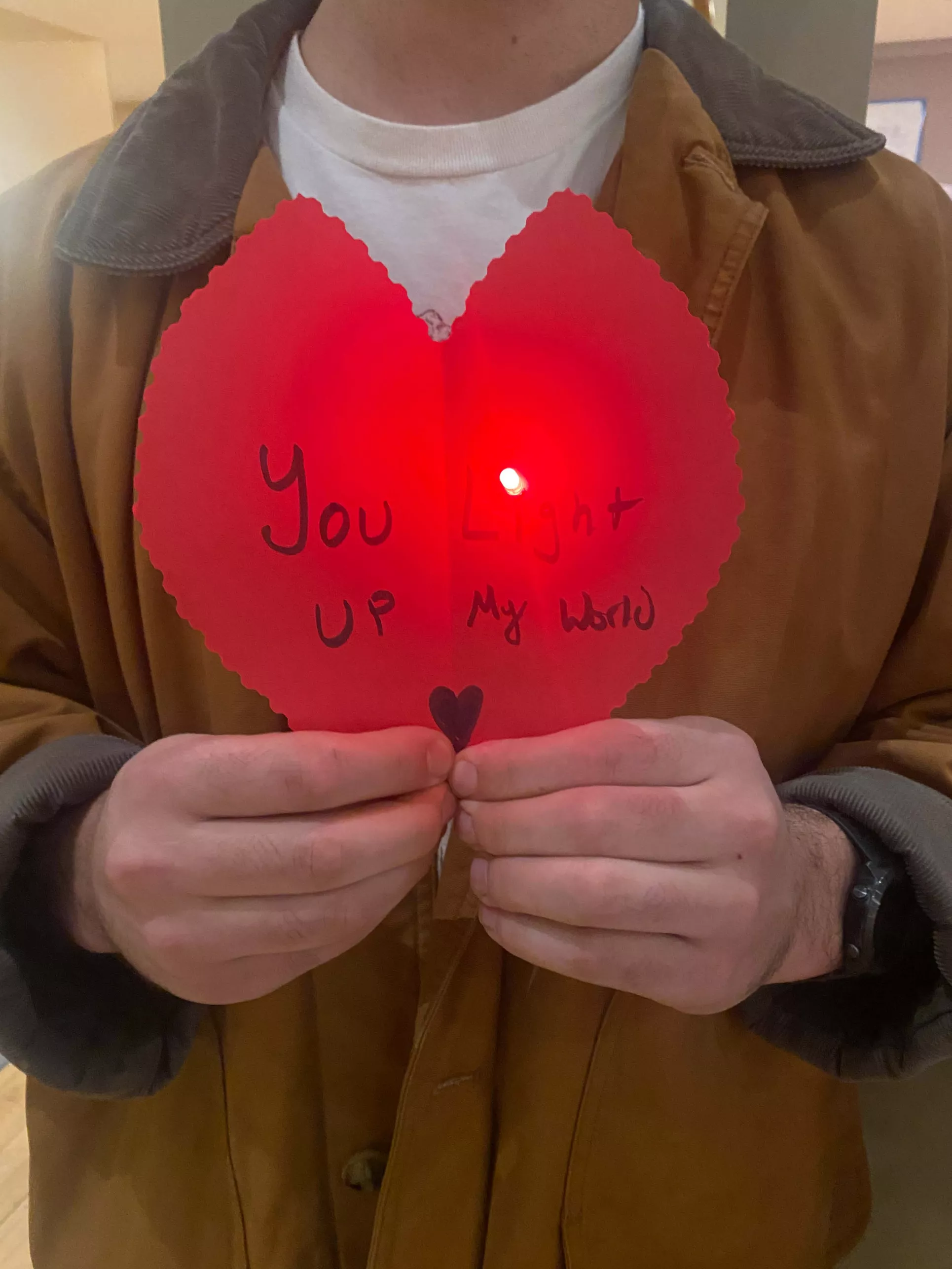 Valentine's Day card made during student workshop. The card is red and heart-shaped, with a red light in the middle. It reads, "You light up my world."