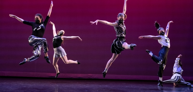 Image of dancers jumping on stage