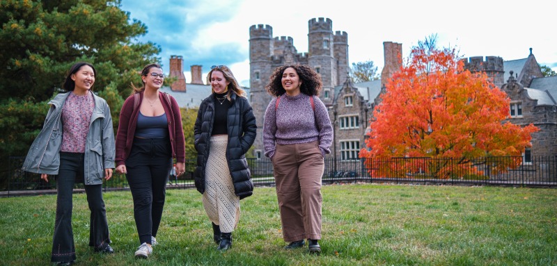 four students walking across campus