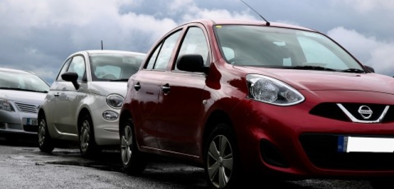 Three cars parked on a road