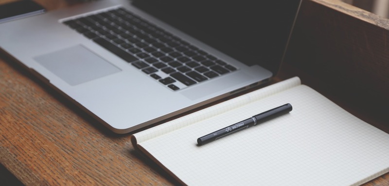 Laptop and Notebook on a Desk