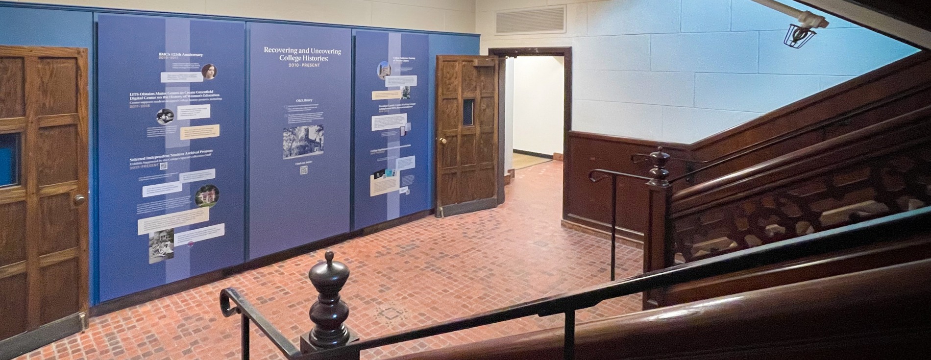 Blue panels with white words at the end of a staircase