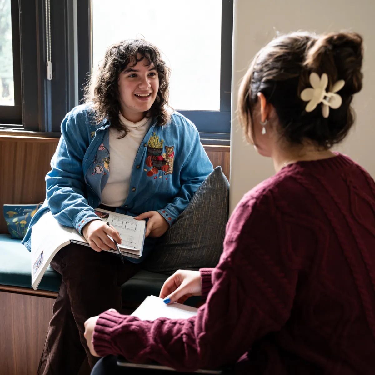 Two students talking in a dorm