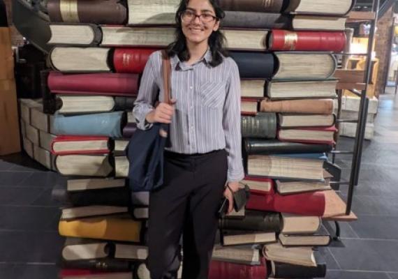 Foqia Sahid standing in front of books