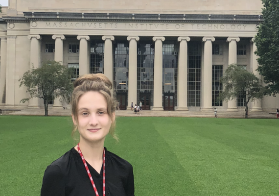 Angelina Rogatch standing in front of a domed building with pillars. 