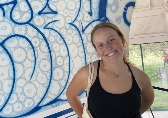 Claire Ford in front of a mural.