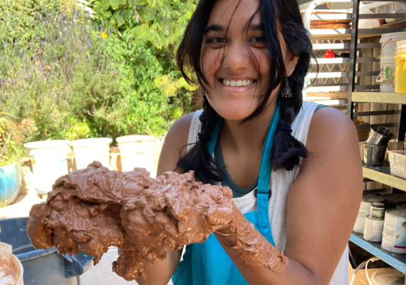 Purnima Palawat smiling while holding mud