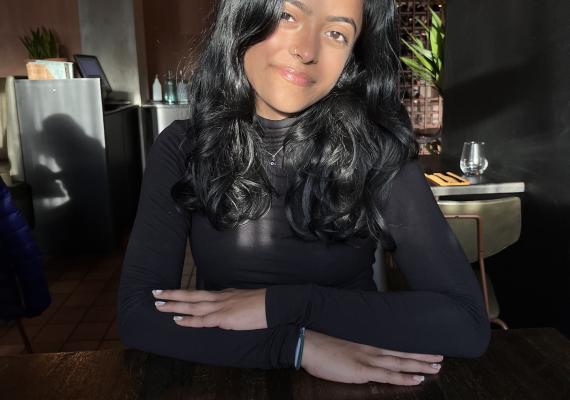 Shaili Lotia sitting at a restaurant table. 