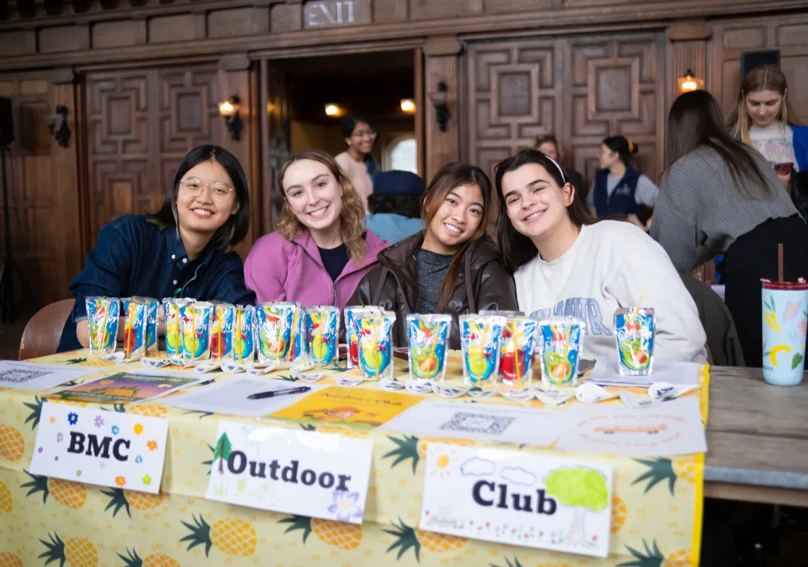 Four students advertising outdoor club