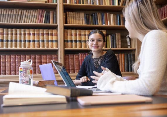 Two students discussing in the library