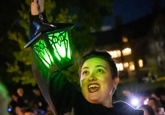 Emily Friedman '03 holding lantern at Reunion Step Sing.