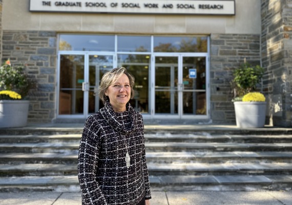 Peggy Robinson standing outside of the GSSWSR building