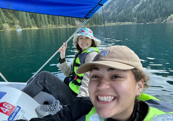 two Boren scholars kayaking on a mountain lake