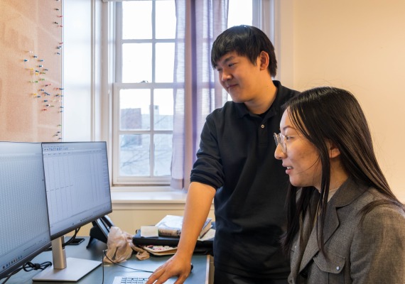 Thomas Le and a student at a computer