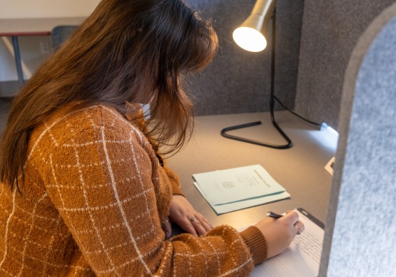 student sitting at a desk in the testing center