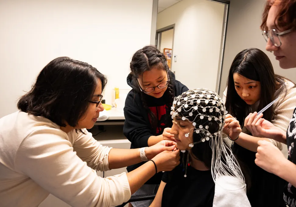 students and faculty work in the lab