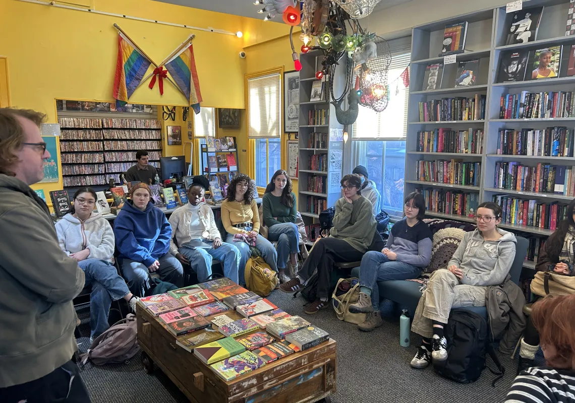 Students sitting inside bookstore.
