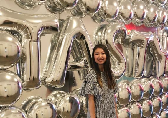 Kellie Stands in Front of BuzzFeed's Tasty Sign