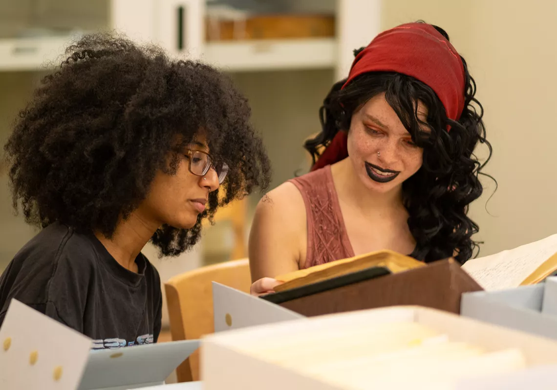 Swarthmore student Shayla Smith and Wynter Douglas '19 (from left) examine documents from Bryn Mawr's Special Collections.