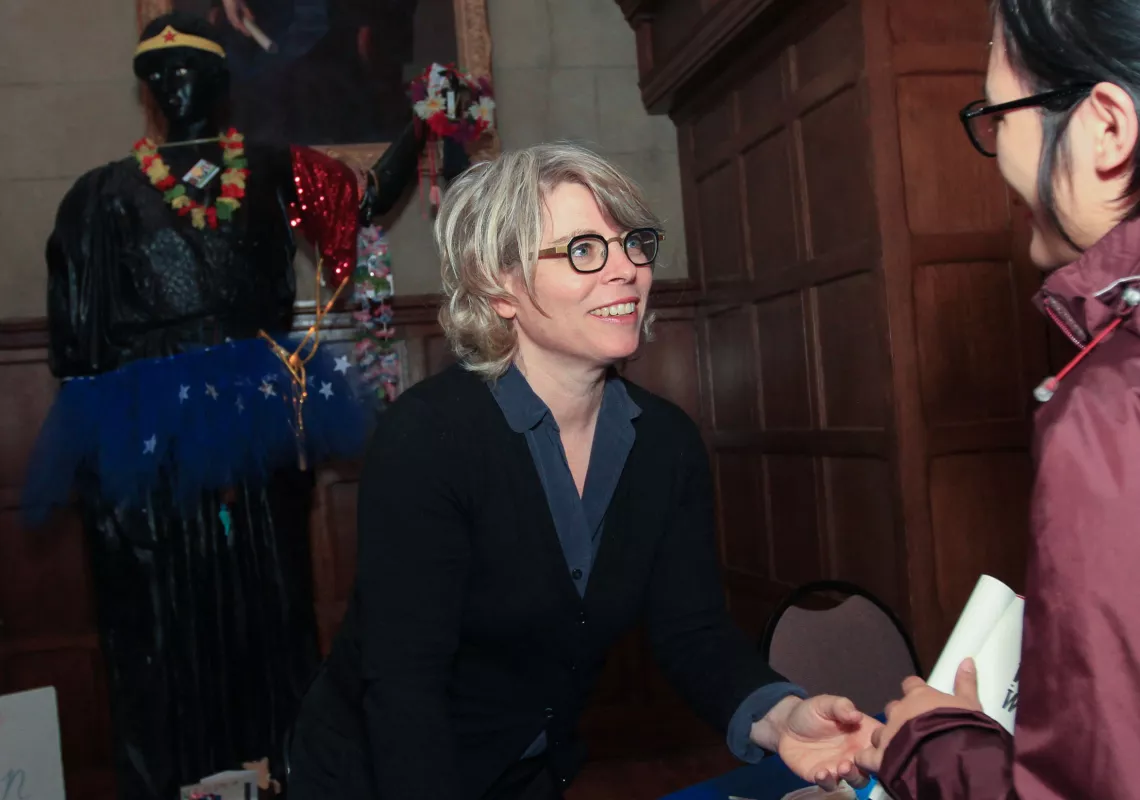 author shaking hands with student
