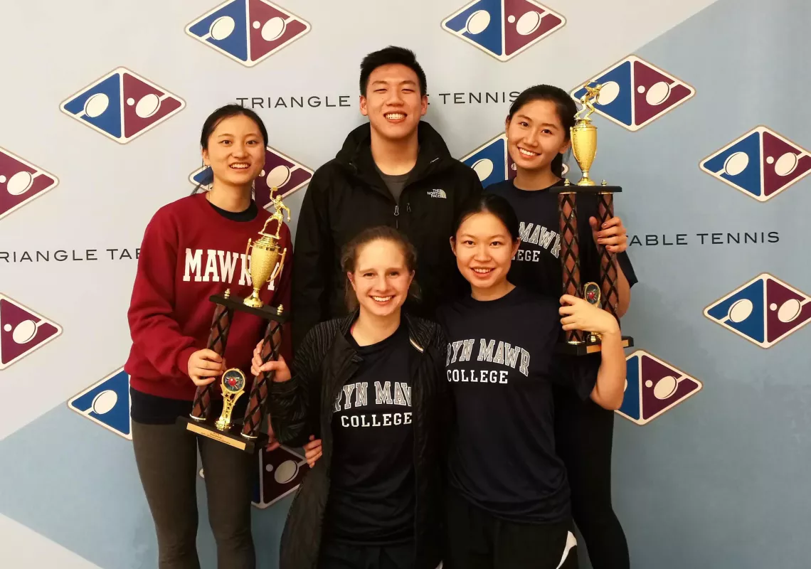 ping pong team with trophy