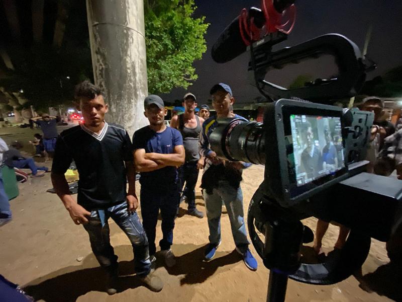 People being interviewed near train tracks