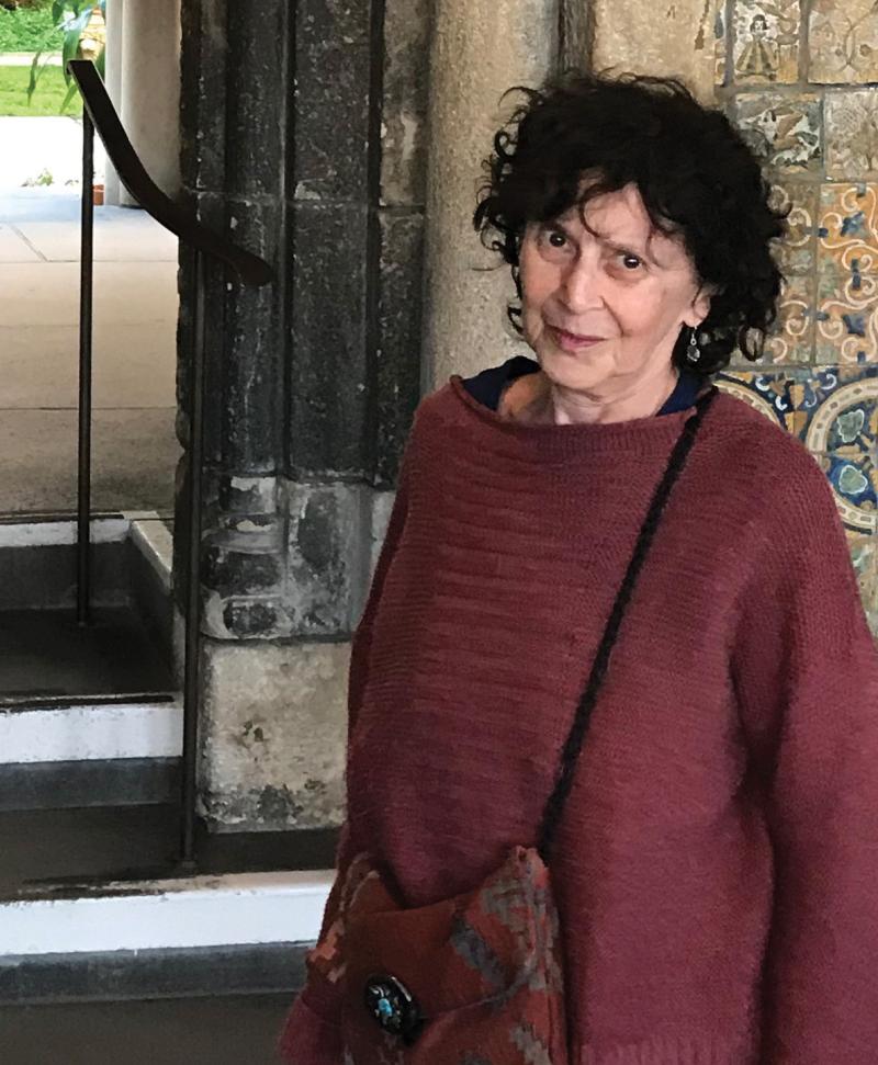 Martha Birnbaum standing in front of a set of stairs