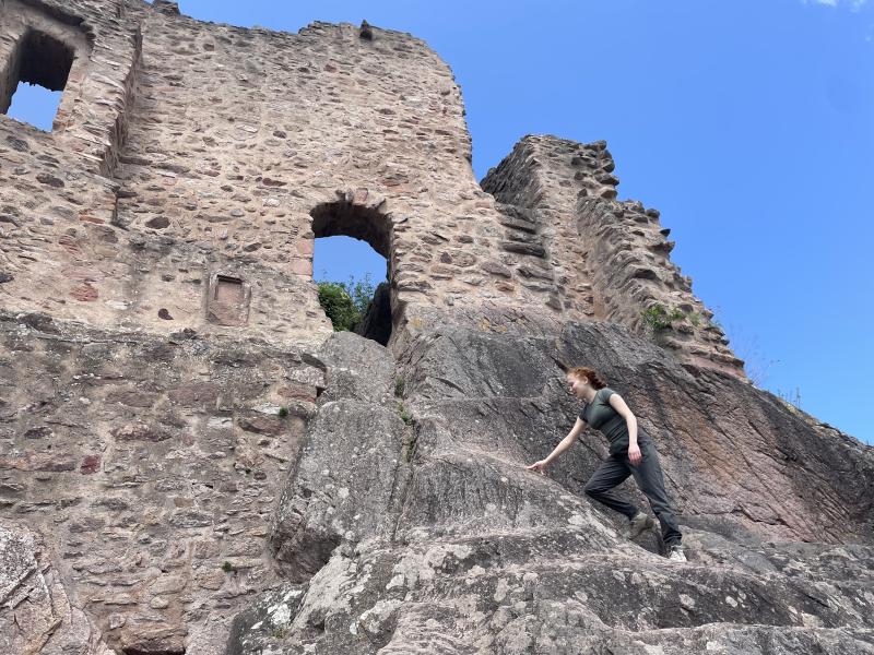 Clara outside climbing a rock